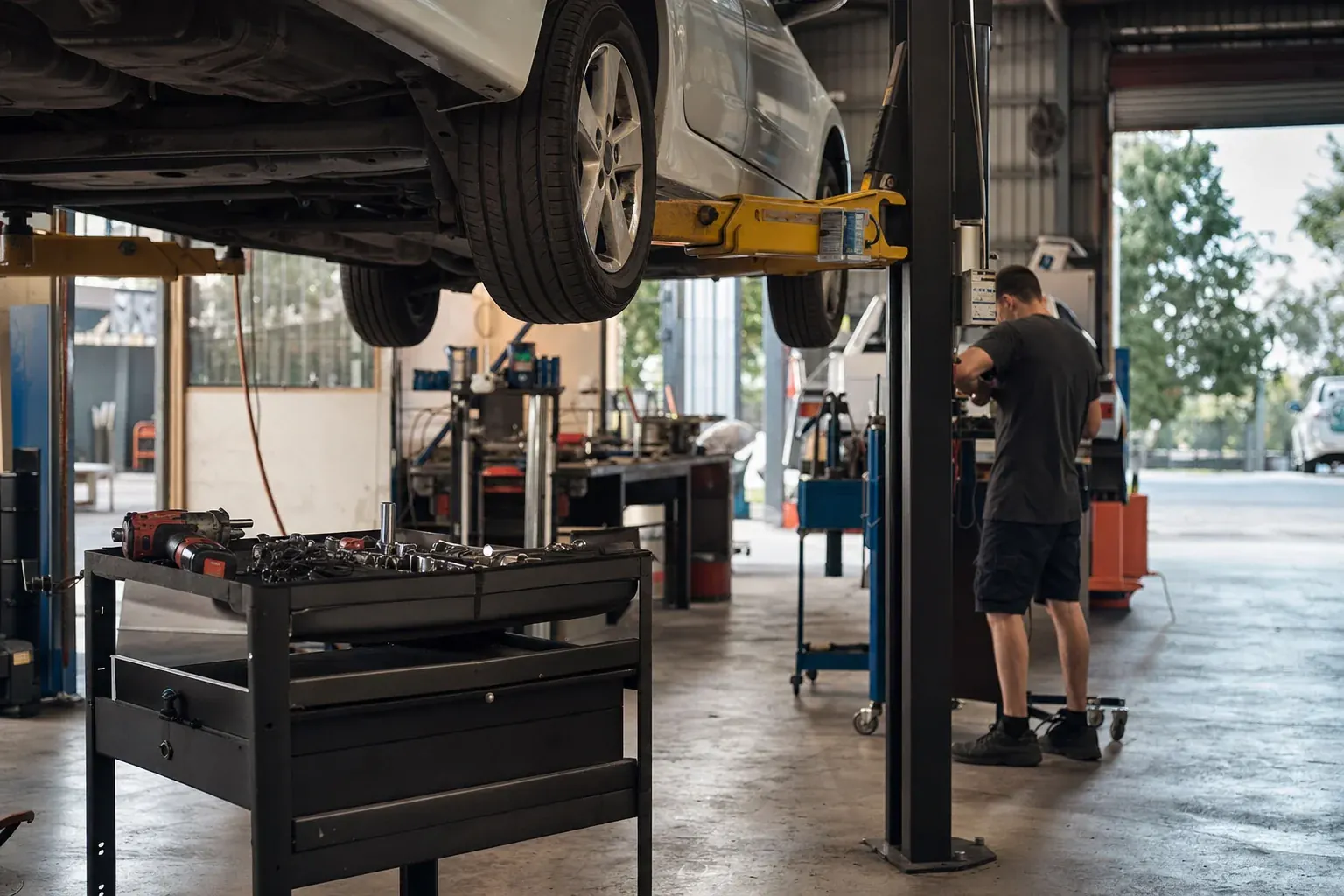 Mechanic reviewing paperwork in an Australian workshop